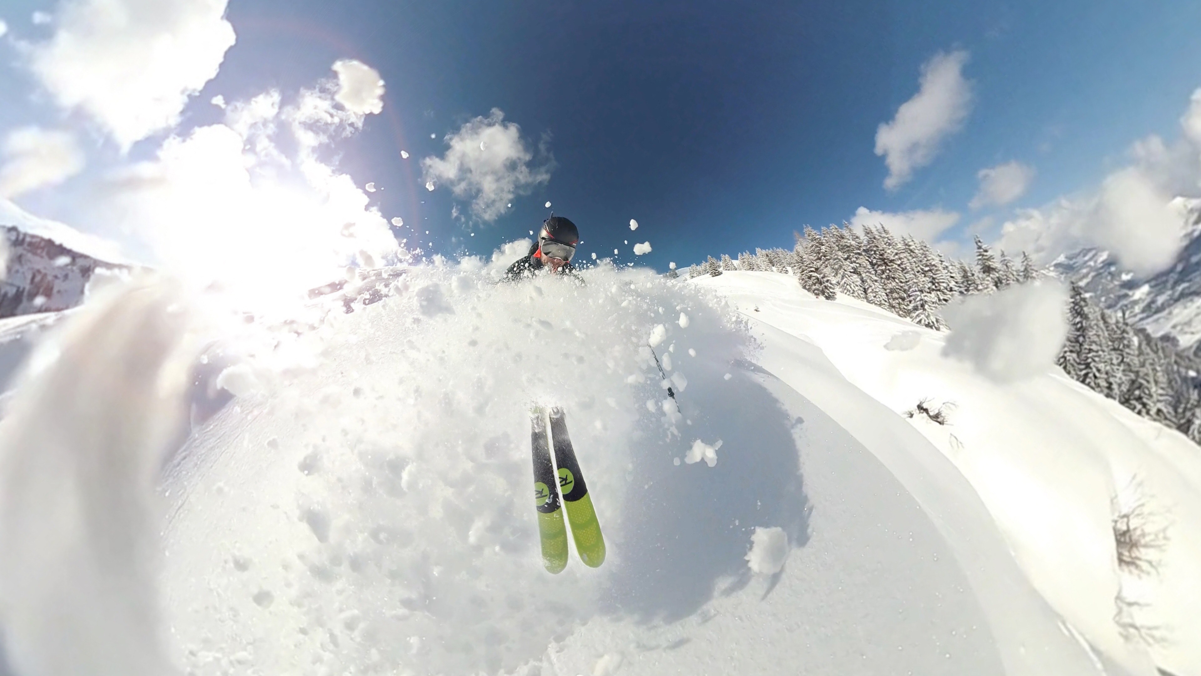 Skier in deep powder snow on a sunny day in the mountains near Bozeman