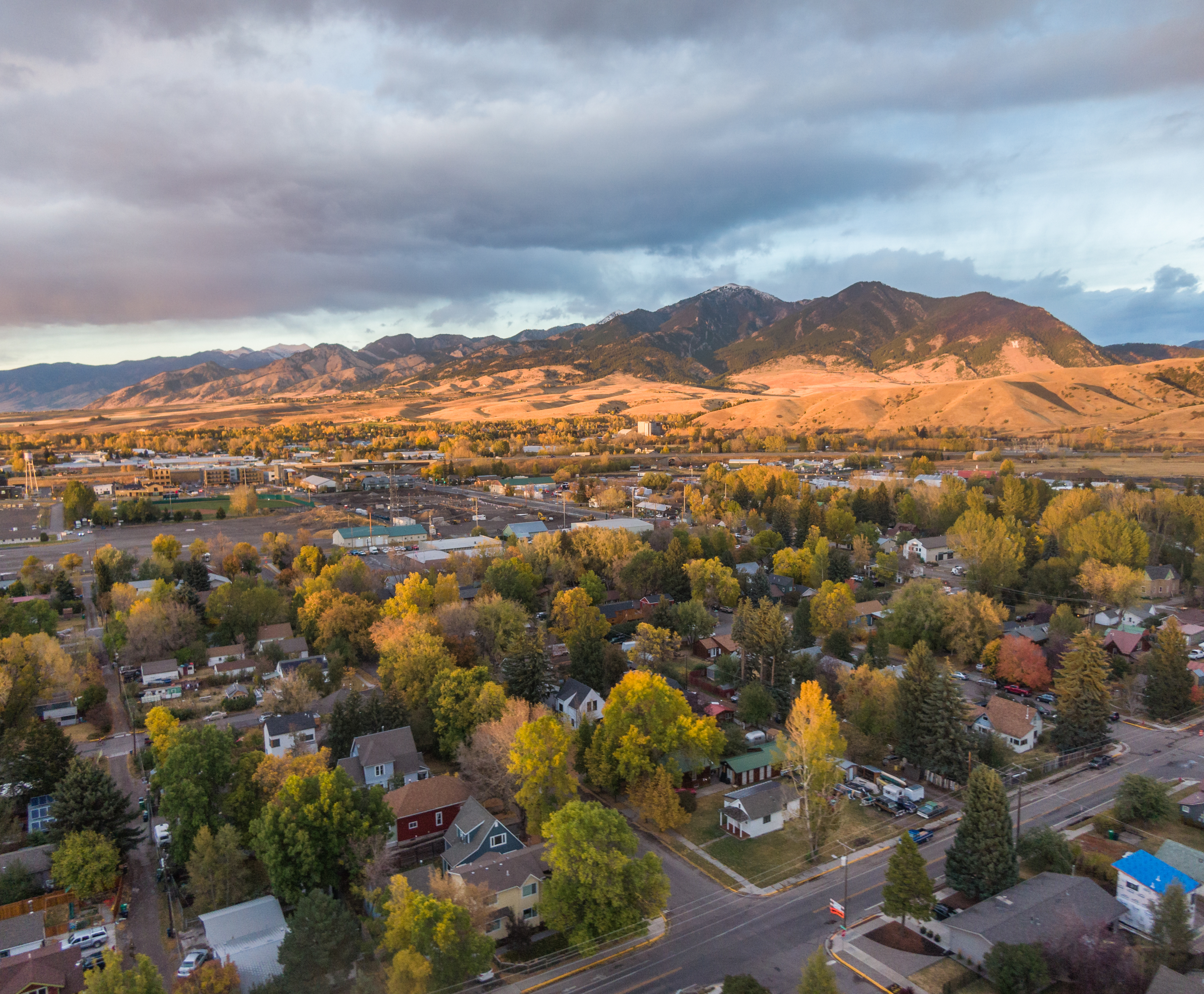 Aerial view of a Bozeman neighborhood and the surrounding mountains at dusk